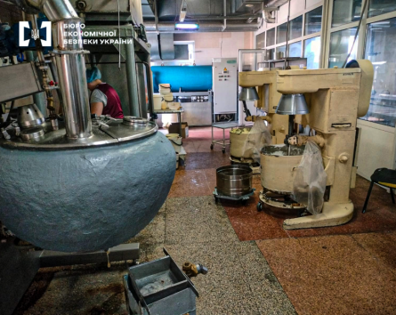 An industrial shop of food production with a large vat and dough mixers