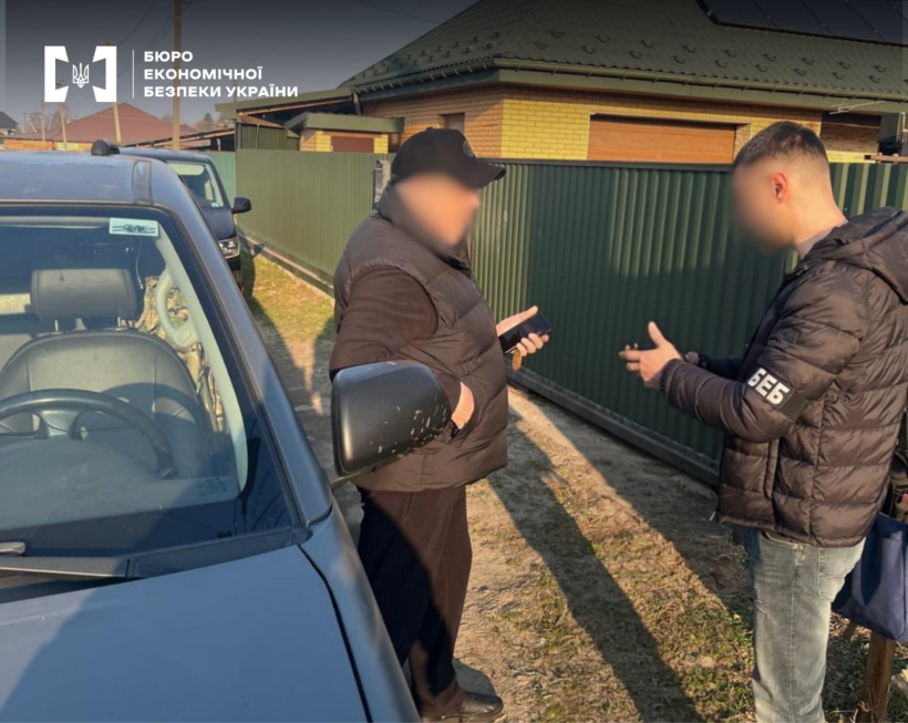 A ESBU detective demonstrates a seized car side mirror that was used as a hiding place for contraband.