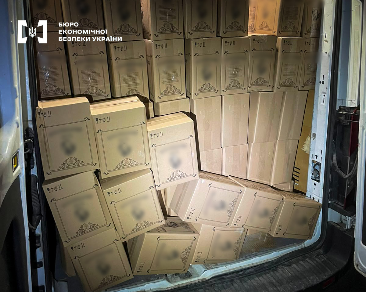 The cargo compartment of a van, completely filled with boxes of illegal alcohol (bag-in-box).