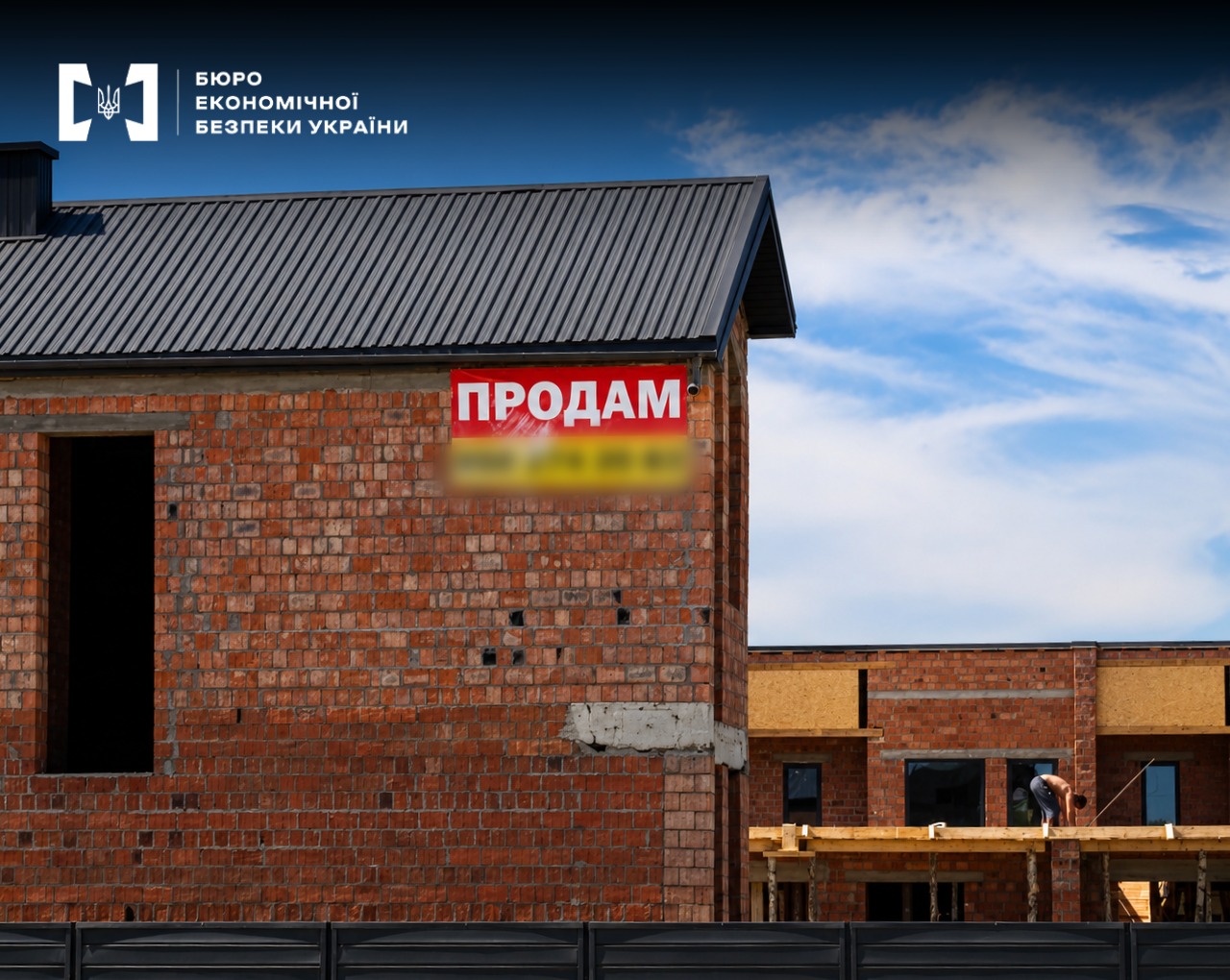 A brick house under construction with a red "For Sale" banner on the facade under a blue sky.