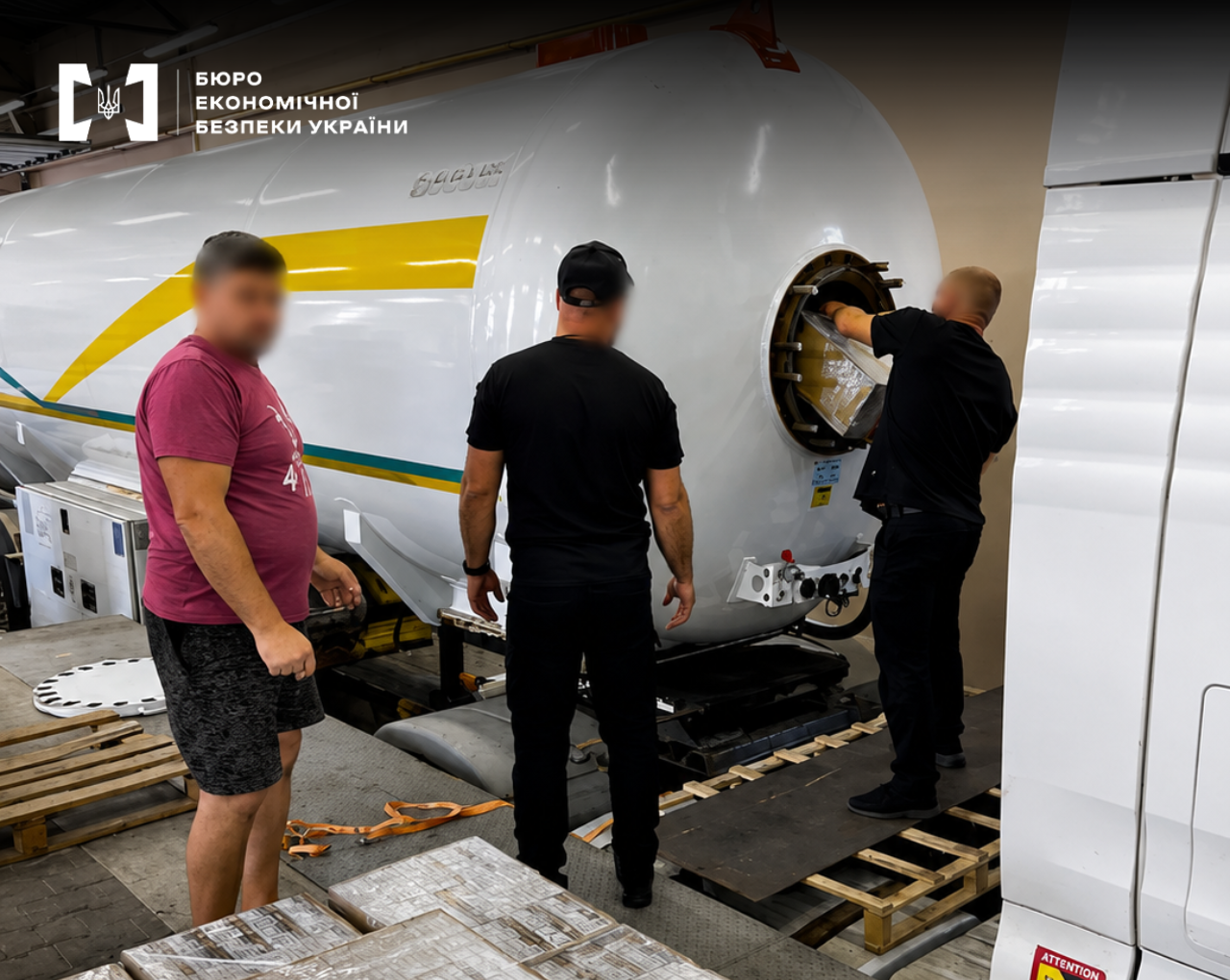 ESBU detectives inspect a hidden compartment in the truck's tanker and remove the concealed goods.