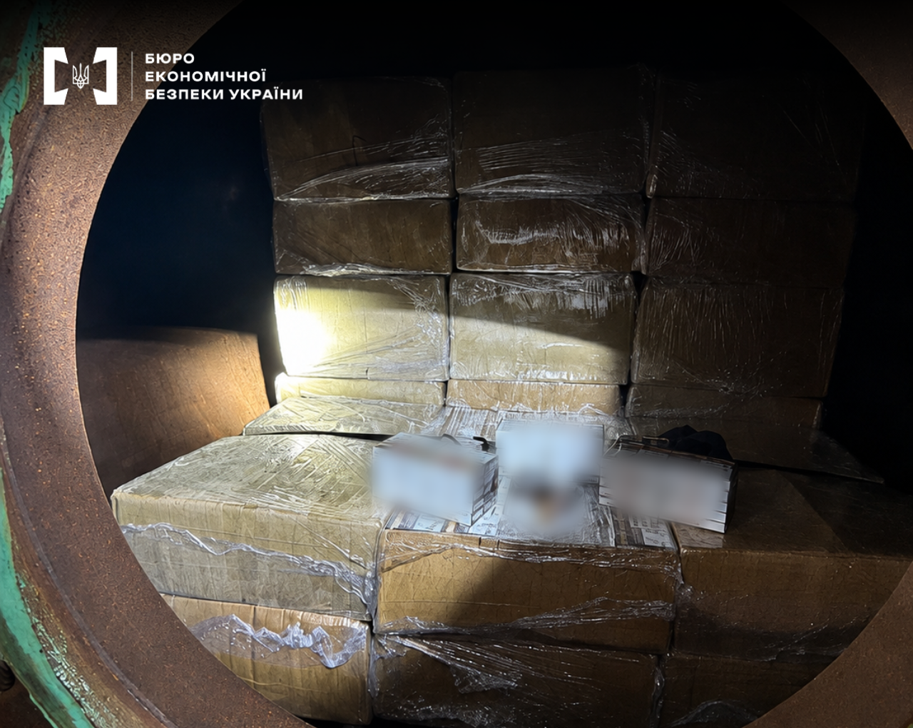 Smuggled boxes in film and cartons of cigarettes inside an industrial tanker.