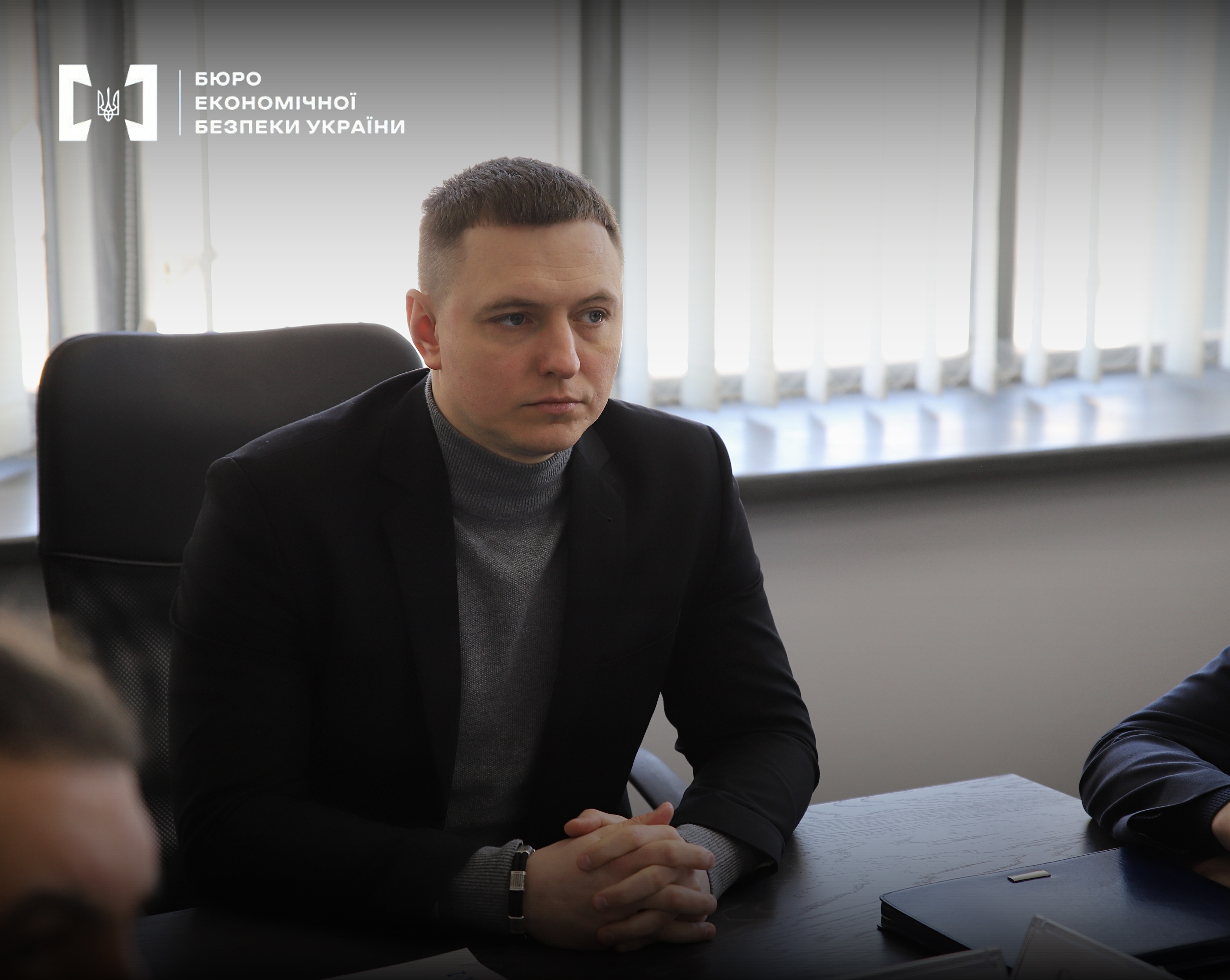 Deputy Director of the Economic Security Bureau of Ukraine Pavlo Buzdygan at the table during a meeting.