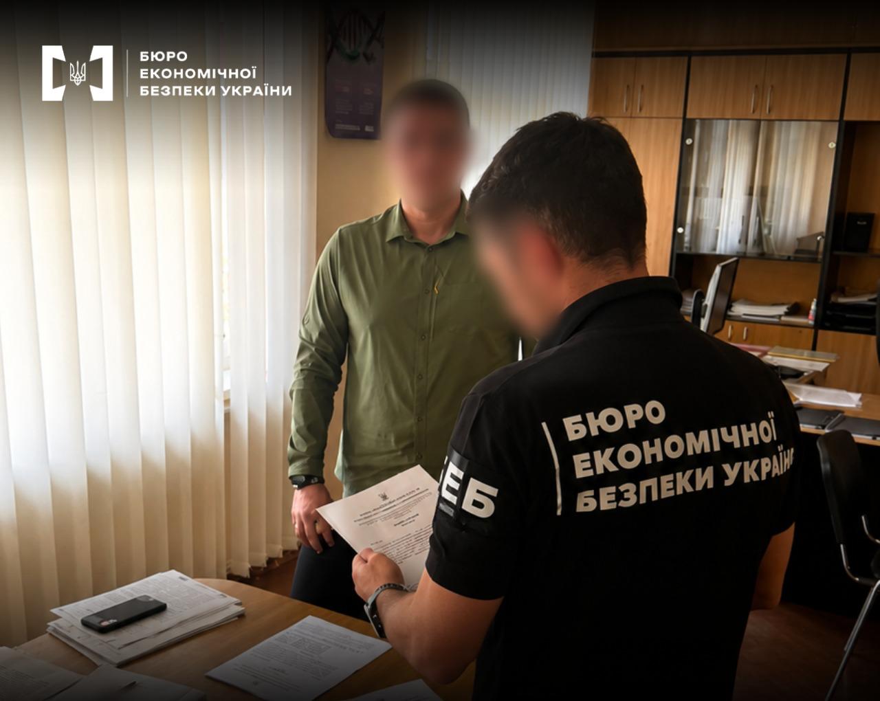 An ESBU detective, with their back to the camera, is holding documents in front of a suspect in the case.