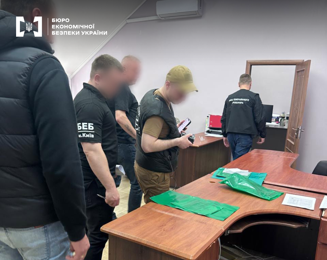 ESBU detectives alongside prosecutors secure evidence during authorized searches. The process of documenting and seizing materials in an office.