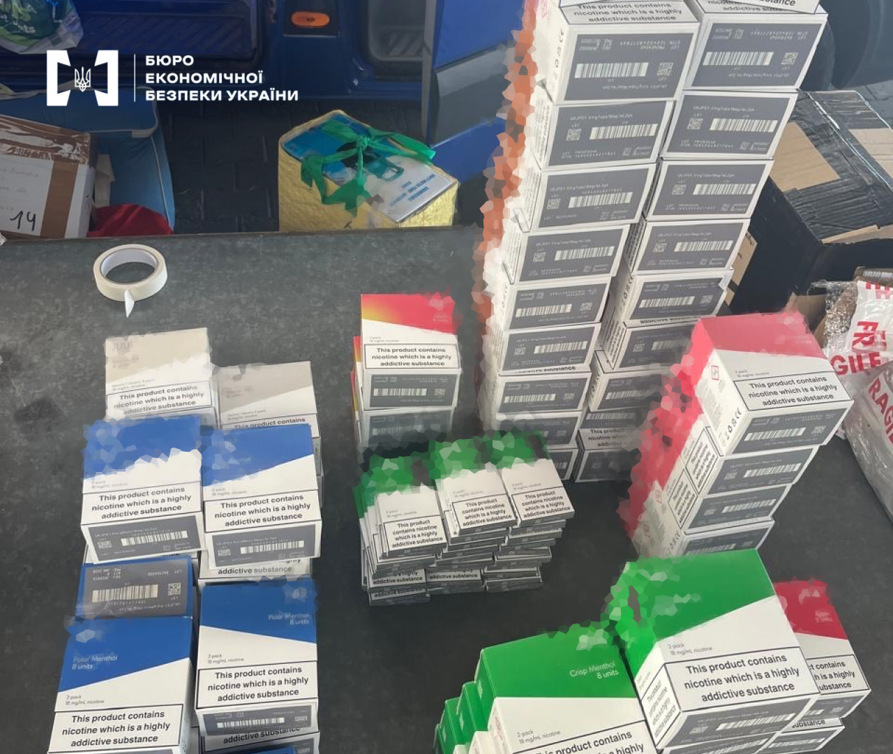 Multi-colored packages of illegal vape cartridges with English labeling.