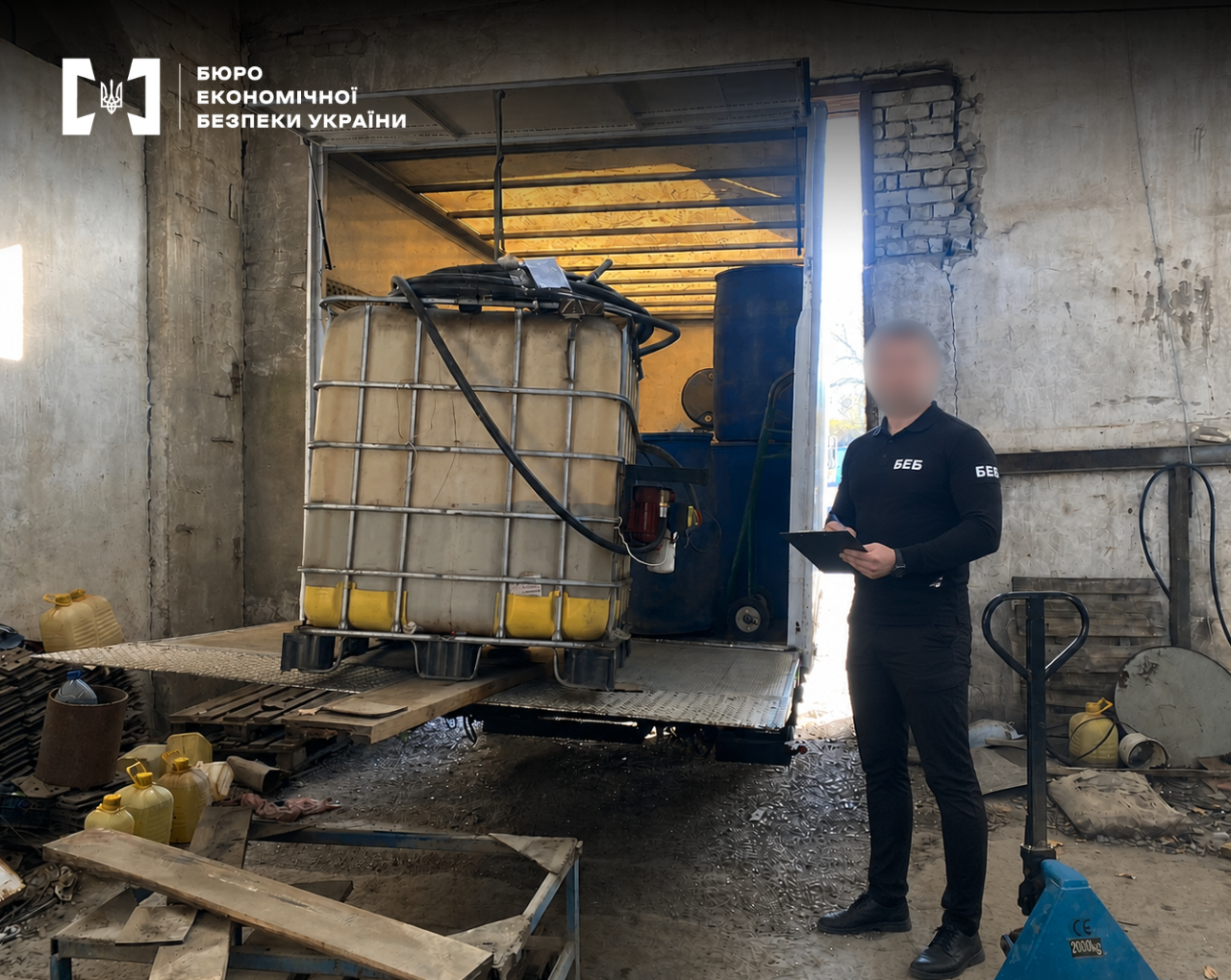 A detective of the Economic Security Bureau of Ukraine inspects a truck with a large liquid container