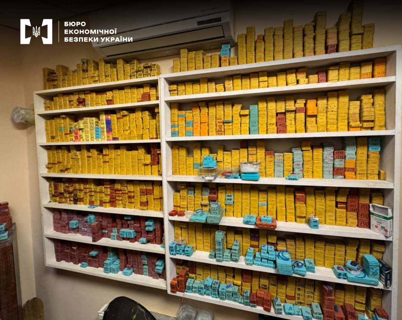 Shelves with numerous numbered yellow and colorful boxes indoors.