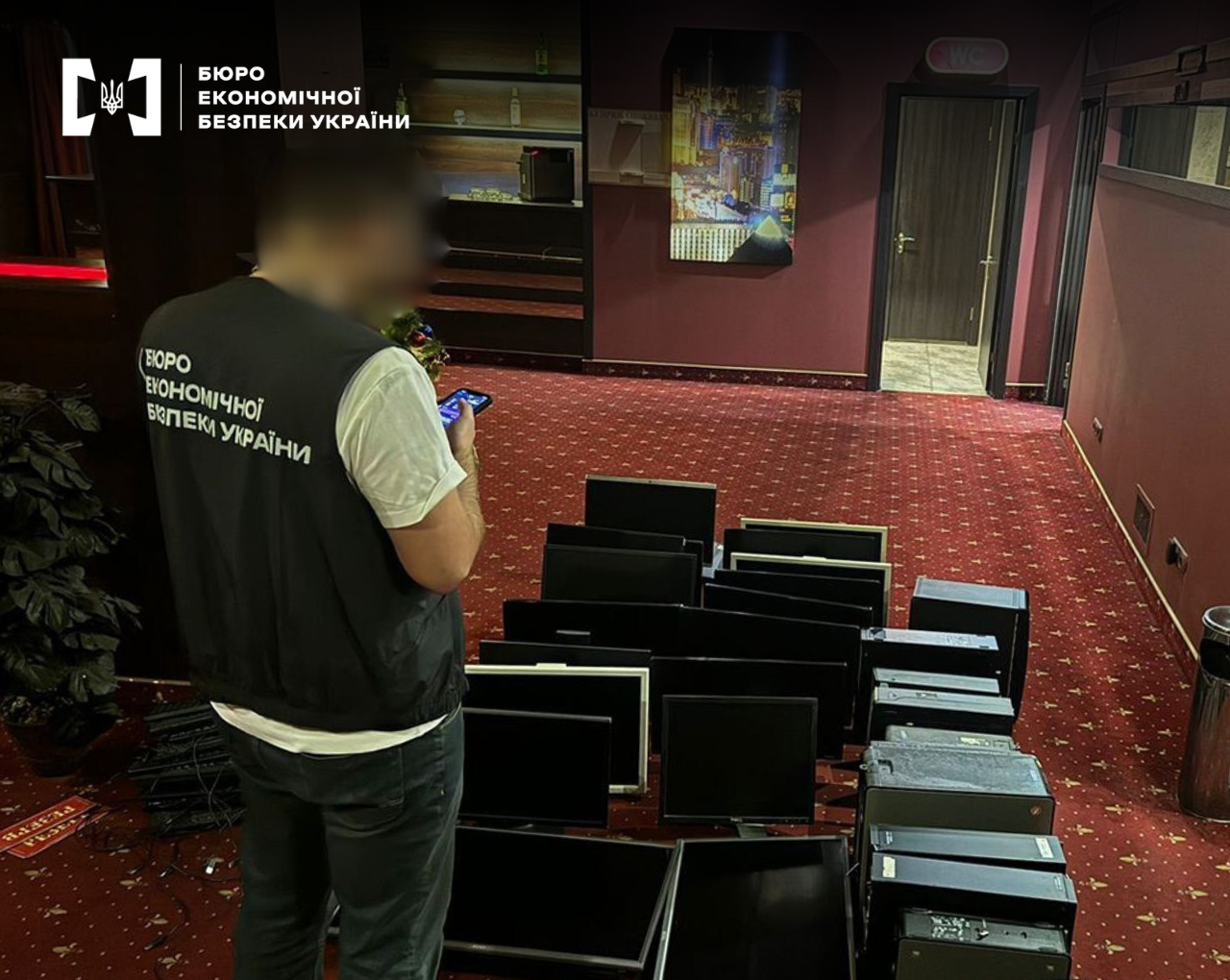 ESBU detectives seizing computer hardware during an operational search. The image shows several monitors and PCs on the floor as part of an ongoing financial crime investigation.