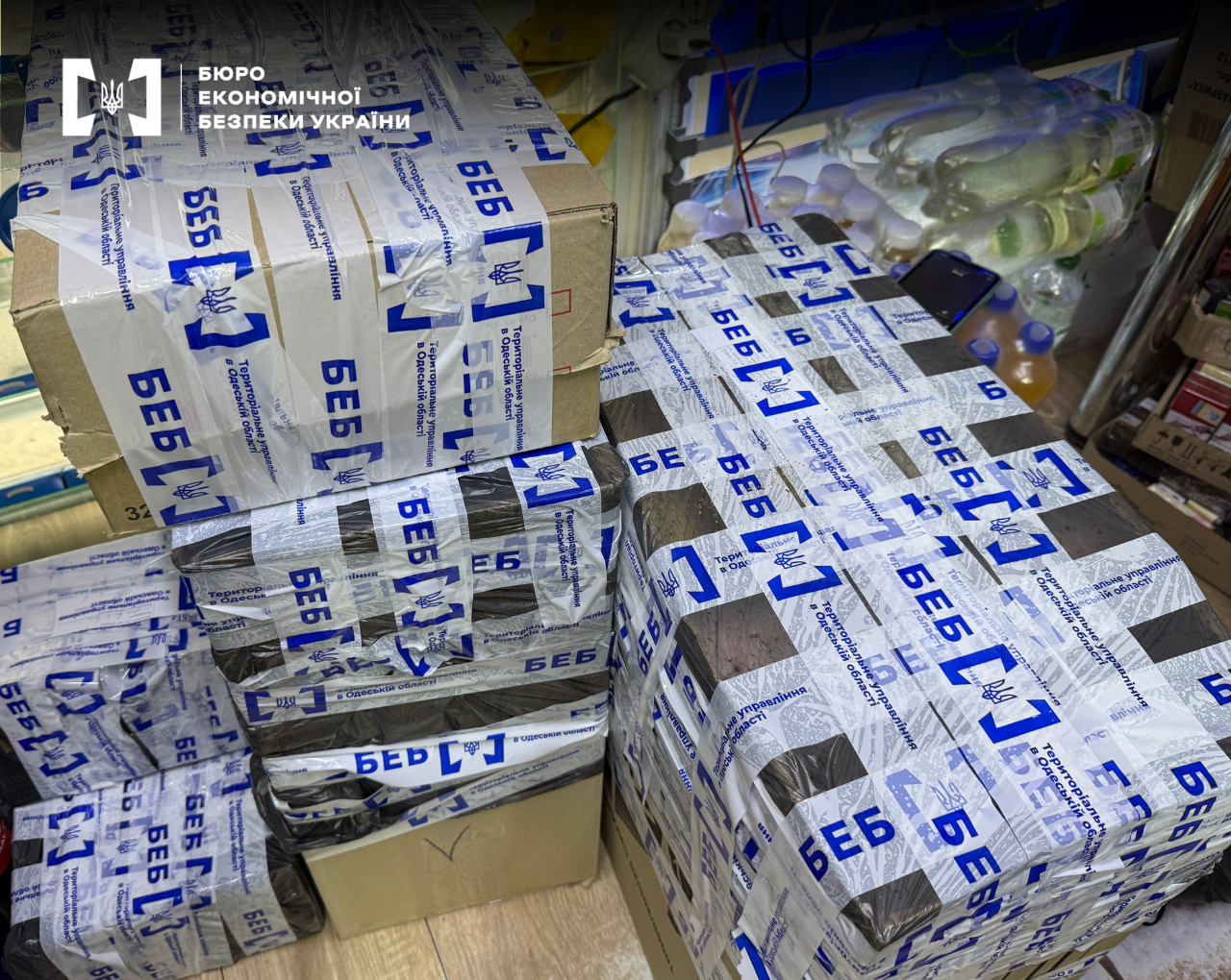 A display case with cigarette packs lacking excise tax stamps or featuring counterfeit ones