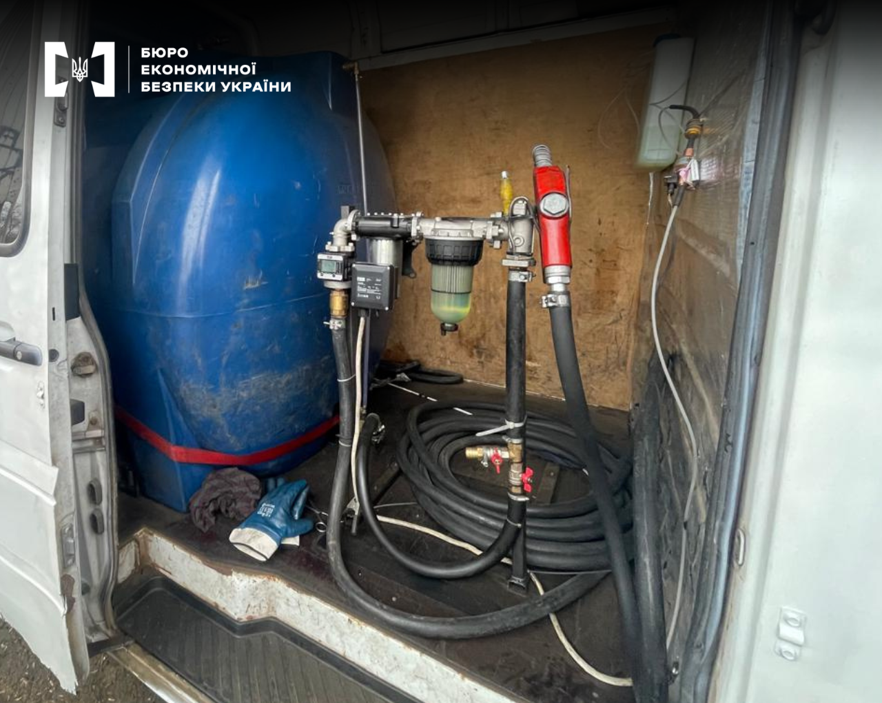 Equipment for illegal fuel dispensing inside a van: a plastic tank, a pump with a meter, a fuel nozzle, and hoses.