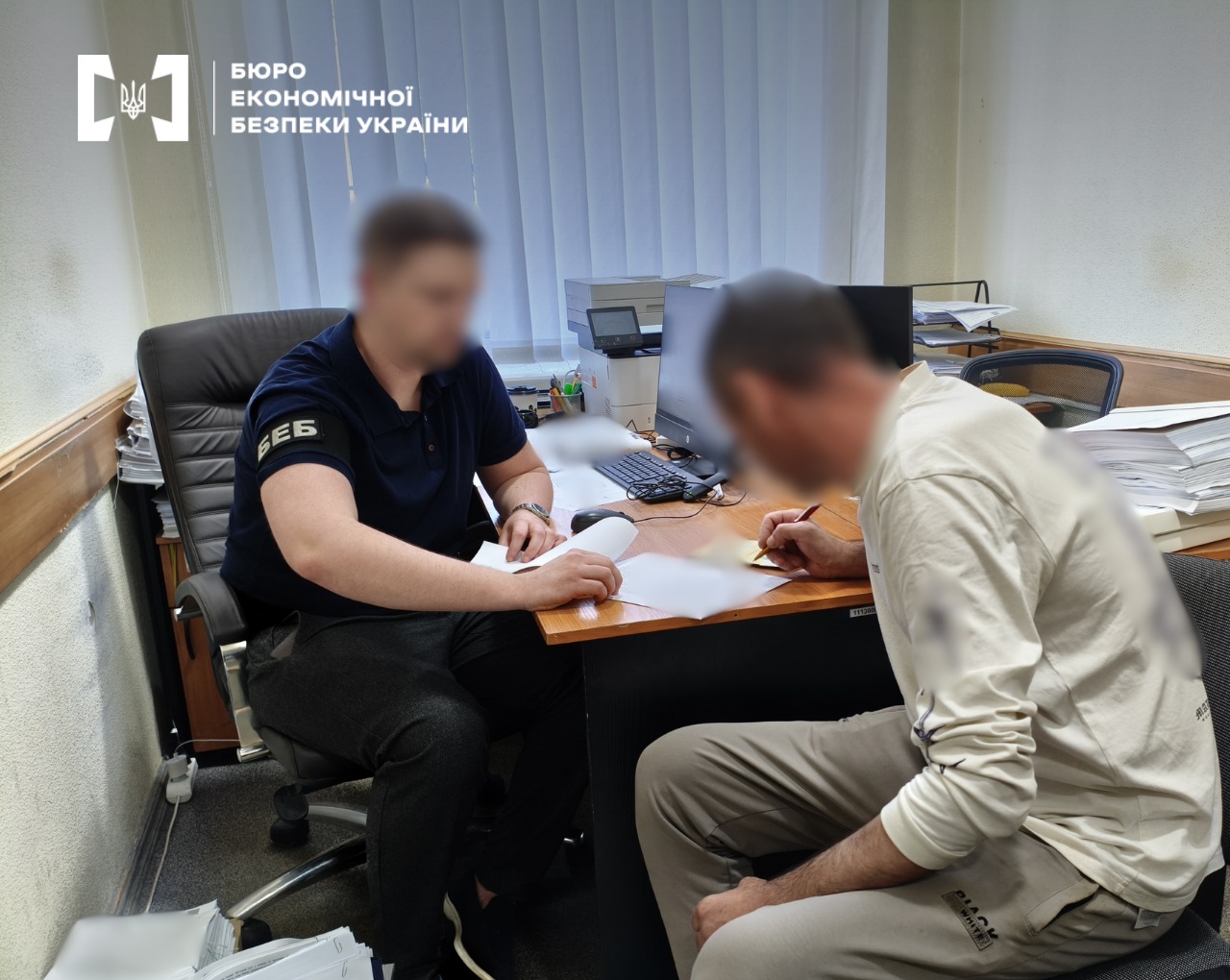 Processing official papers and signing documents at an office desk near a PC.