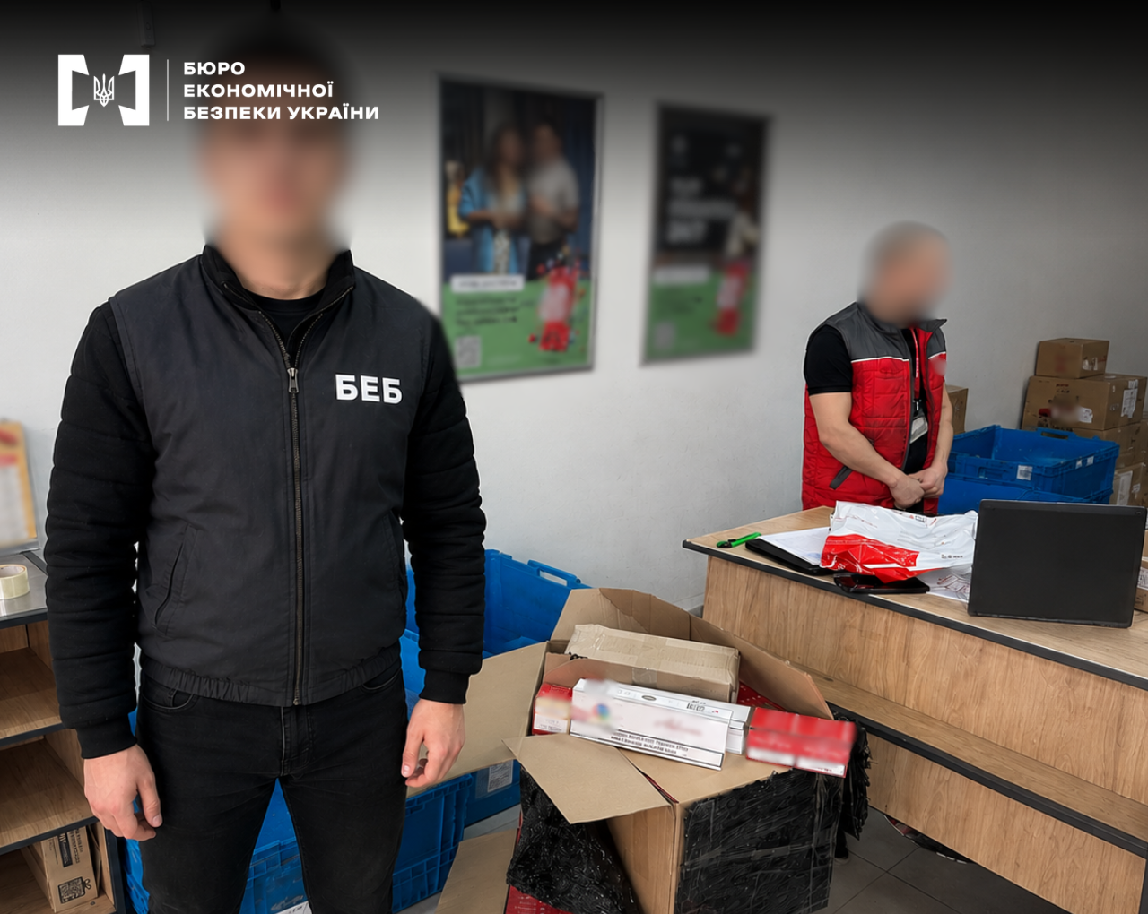 A ESBU detective conducts a search in a post office, with an open box containing cartons of cigarettes in the foreground.