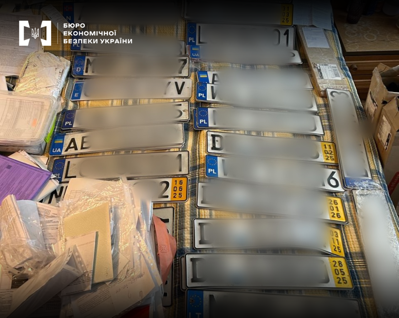 Foreign and Ukrainian vehicle registration plates next to documents.