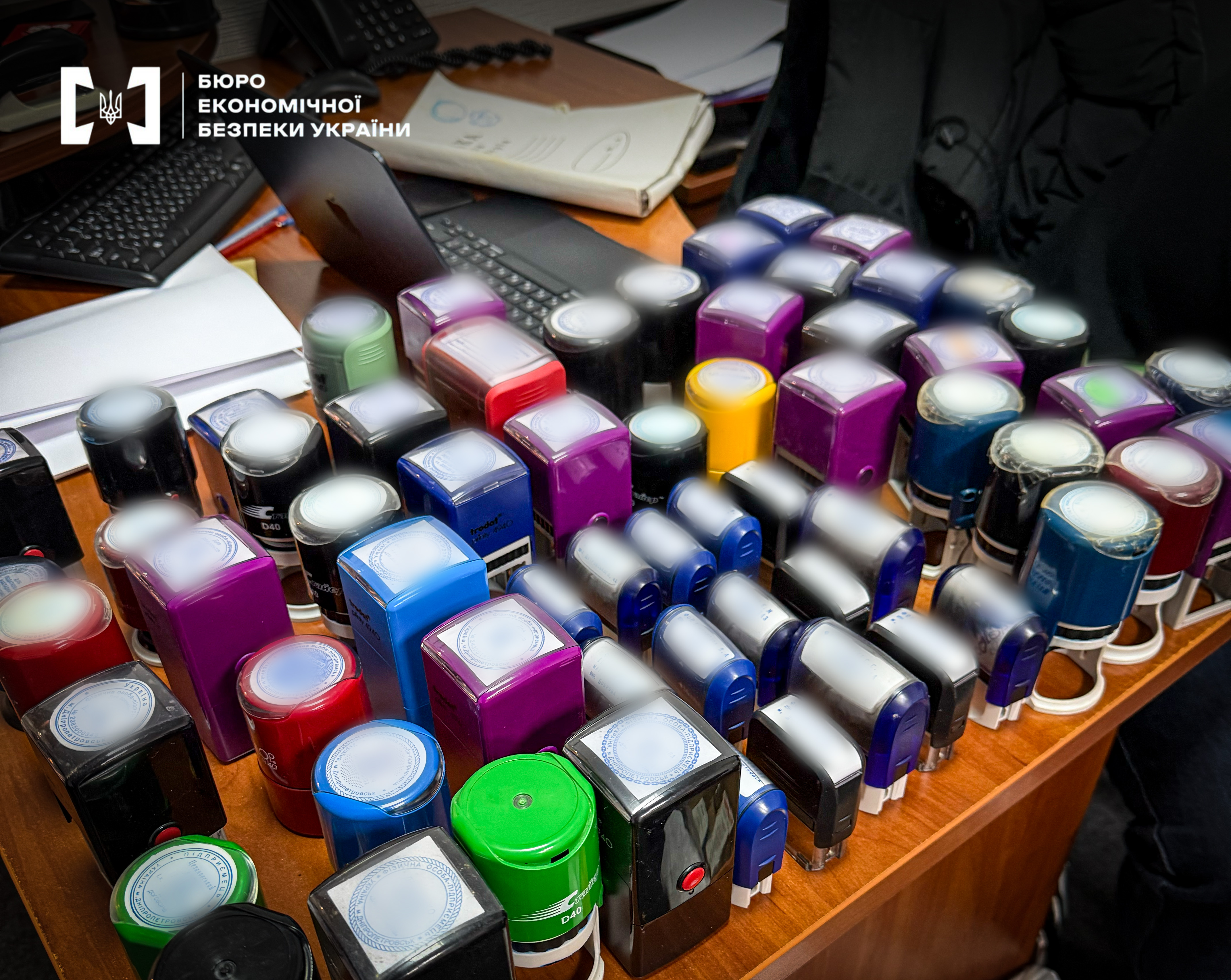 Rows of multi-colored plastic stamp mounts on a desk