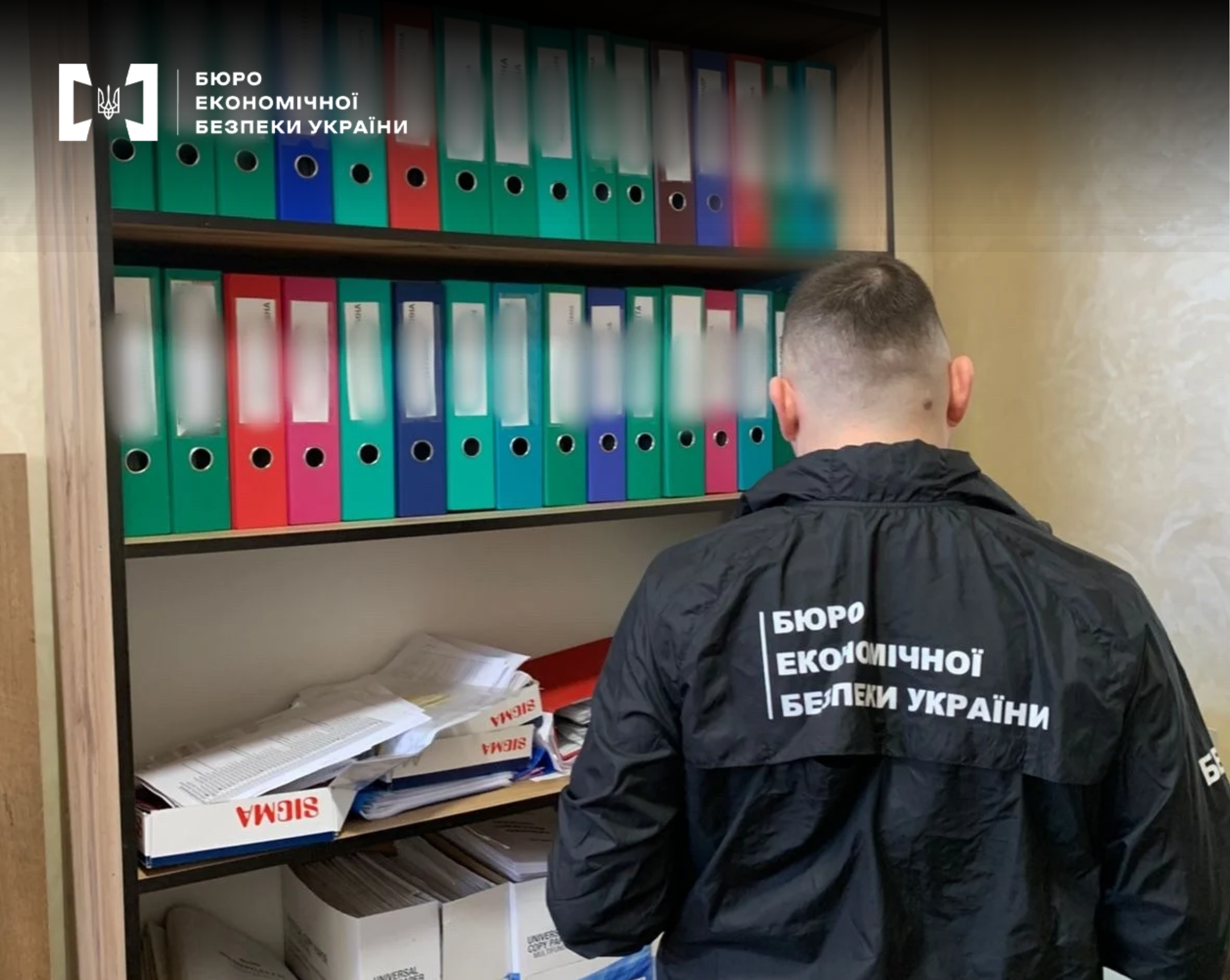 A ESBU detective inspects folders with documents on wardrobe shelves during a search.