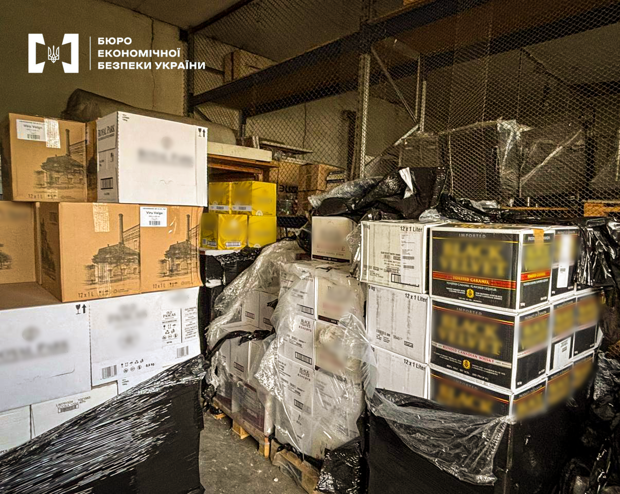  warehouse facility filled with numerous boxes of alcoholic products, some of which are wrapped in protective plastic film