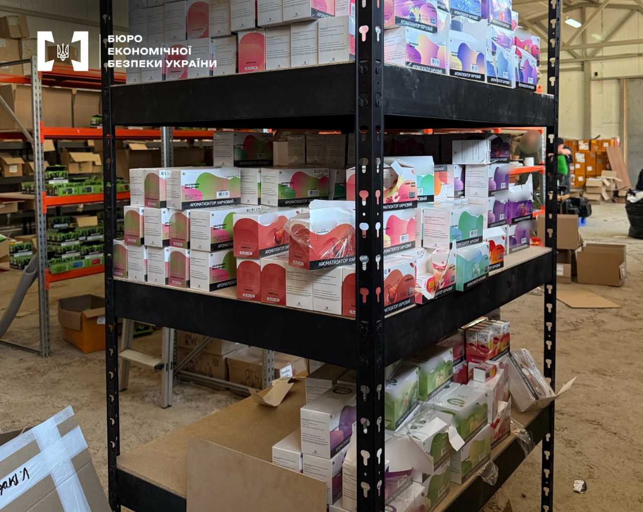 Boxes with food flavorings arranged on the shelves of a warehouse rack.
