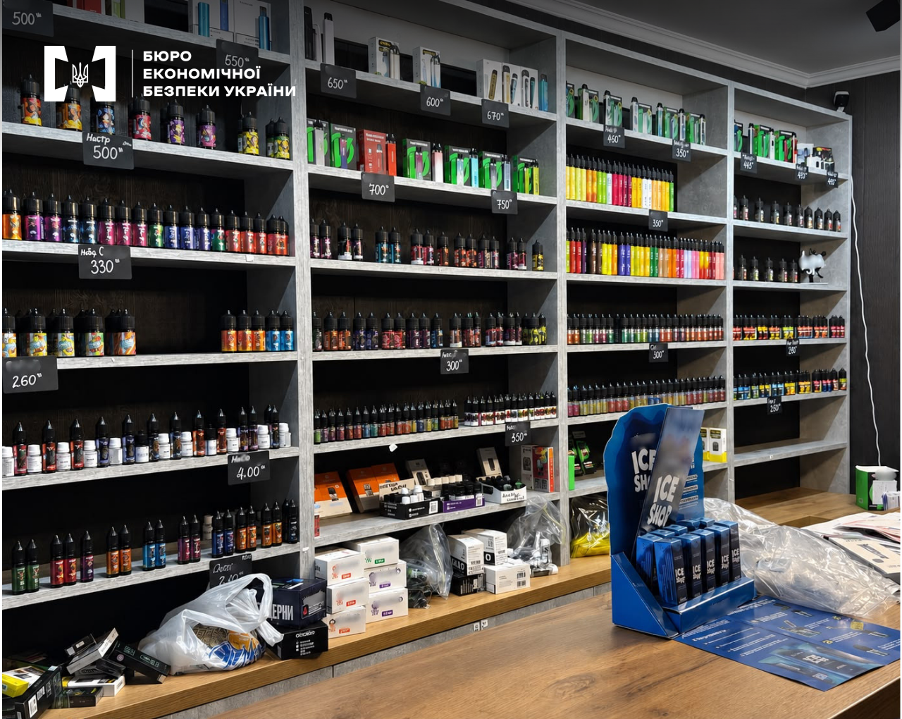 Shelving units in a store with a large assortment of e-liquids and electronic cigarettes