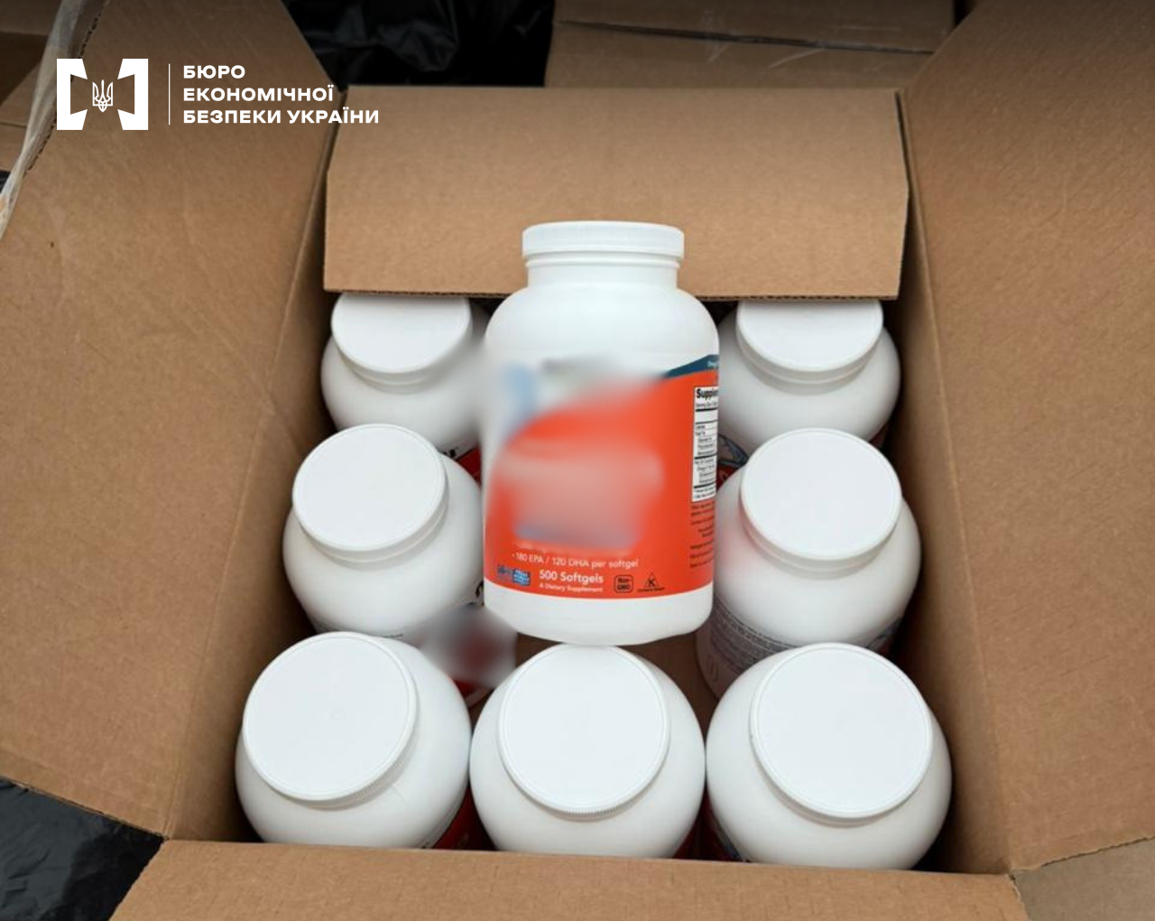 A large batch of foreign dietary supplements and Omega-3 without excise stamps or labeling, seized by the ESBU, in a cardboard box.